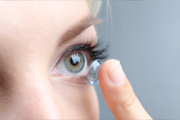 Woman putting contact lens in eye - Contact Lens Fitting - Licensed opticians - Disposable contact lenses exams - Boardwalk-Optometry